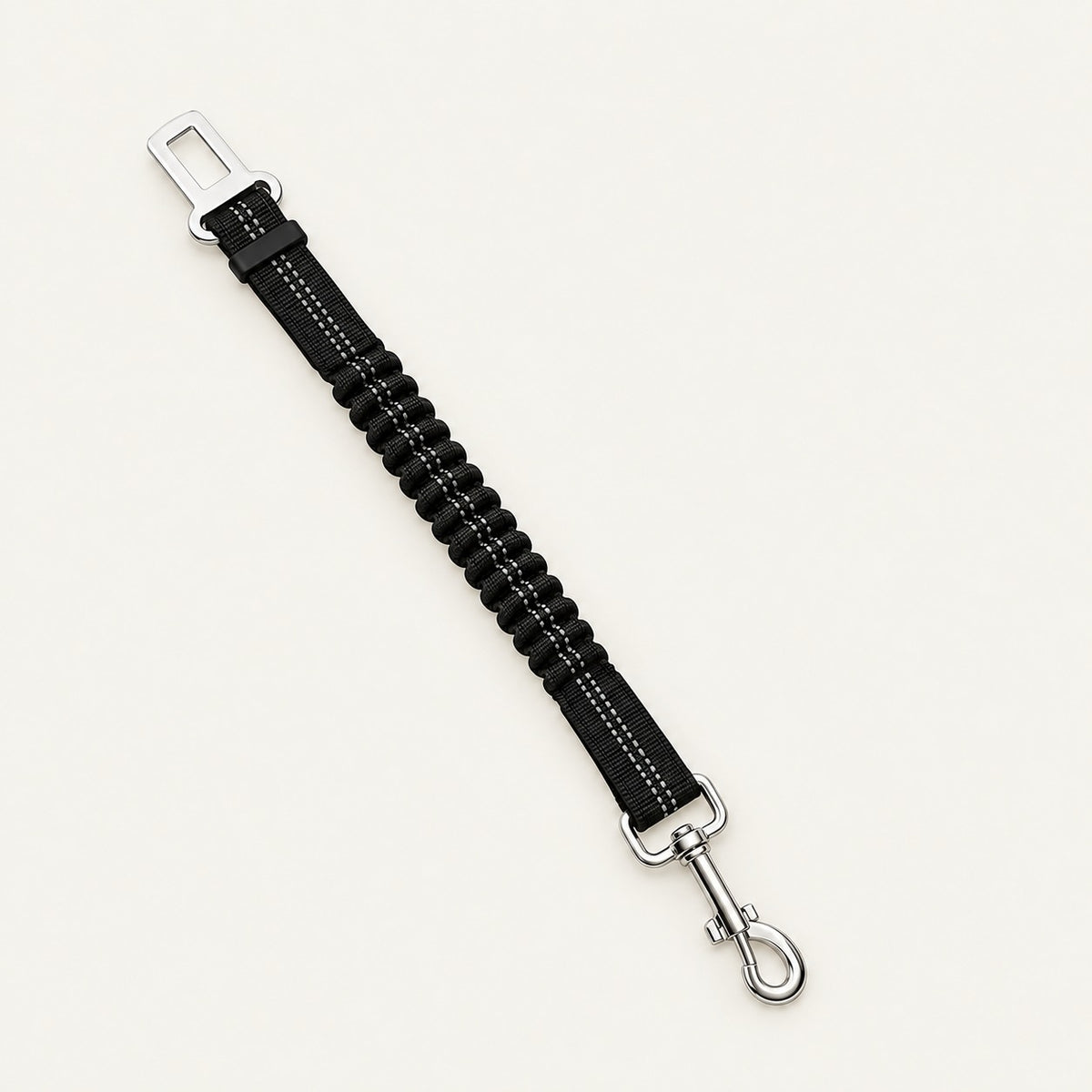 A single black dog car seatbelt tether with a ribbed bungee mid-section, grey reflective stitching, a chrome seatbelt buckle tongue at one end and a chrome swivel snap hook at the other