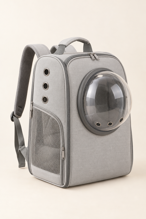 A light grey foldable pet carrier with a clear round bubble window on the side, standing upright on a warm cream background.