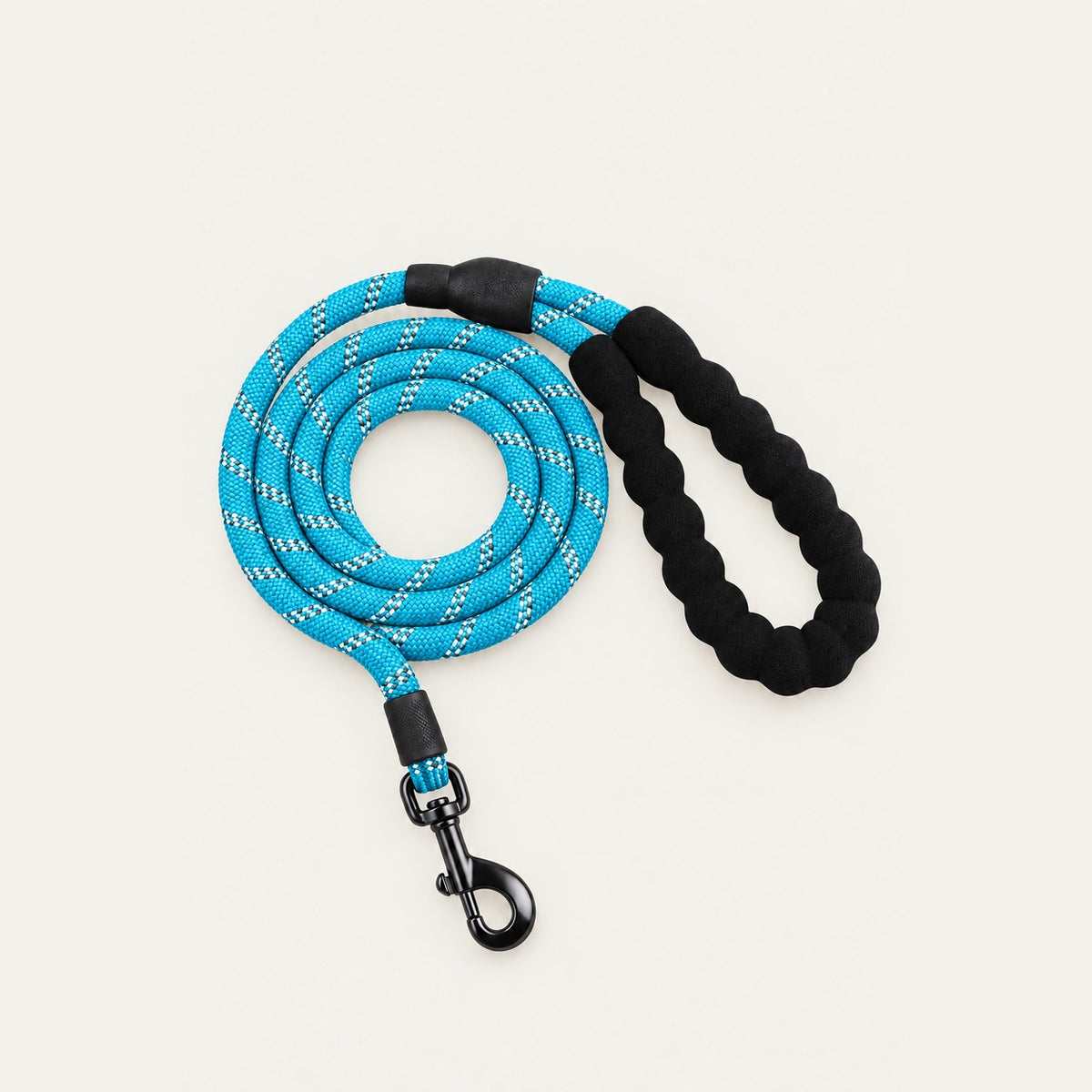 Coiled turquoise-blue rope dog leash with white reflective threads, black padded braided handle loop and dark metal swivel snap hook