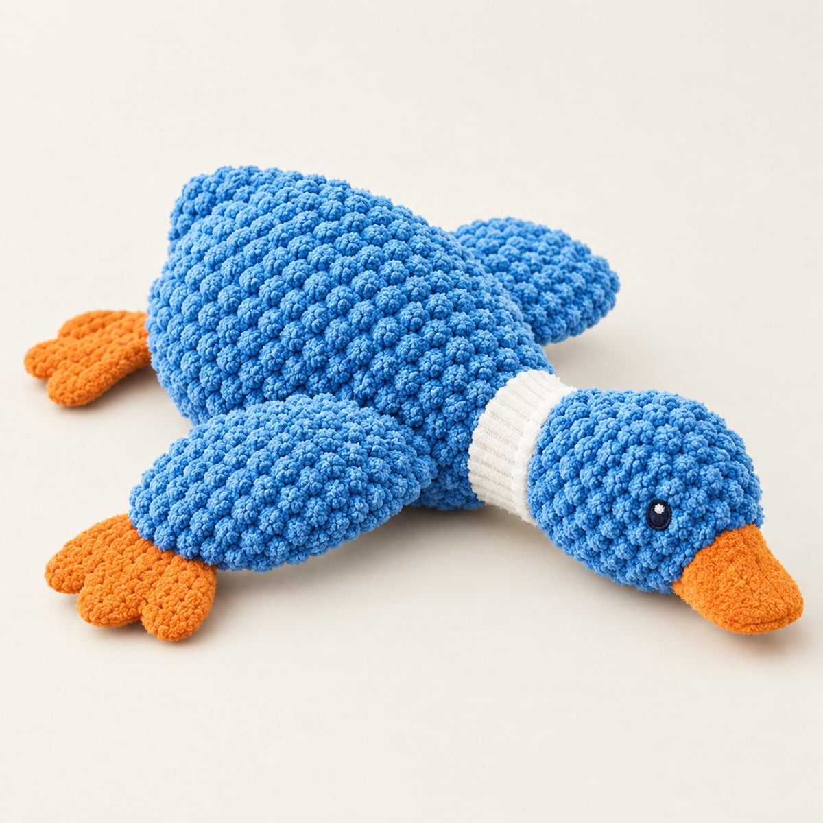 Blue plush mallard squeaky dog toy with bobble knit texture, ribbed white neck ring and orange bill and feet