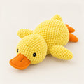 Yellow plush duck squeaky dog toy with raised bobble knit texture and flat orange bill and feet