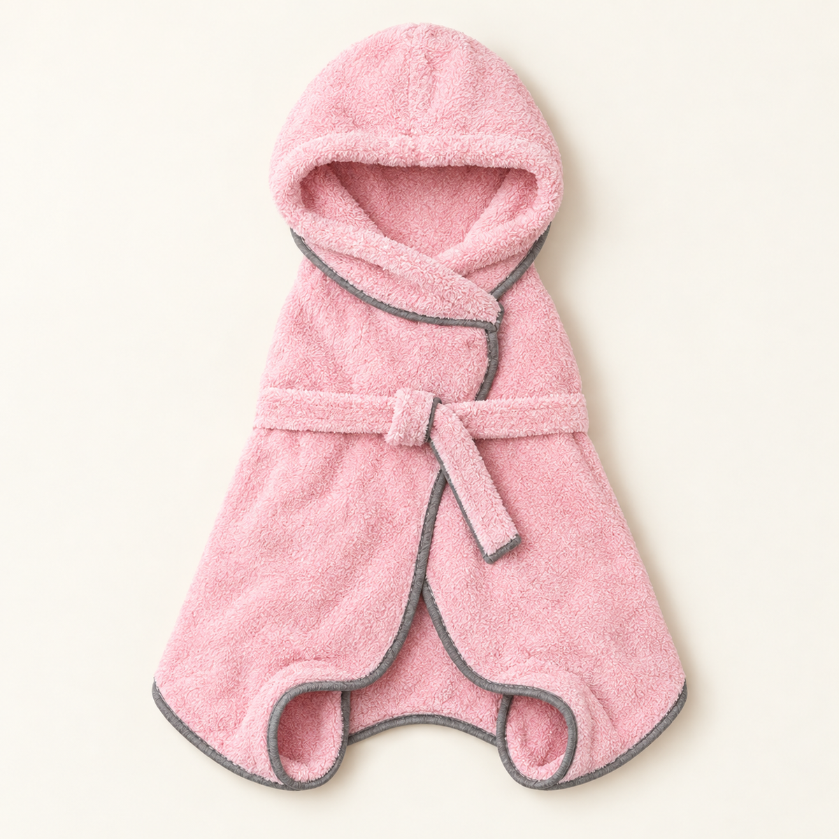 Blush pink plush microfibre dog drying robe with a hood, grey trim, a belt tie and four leg openings, laid flat