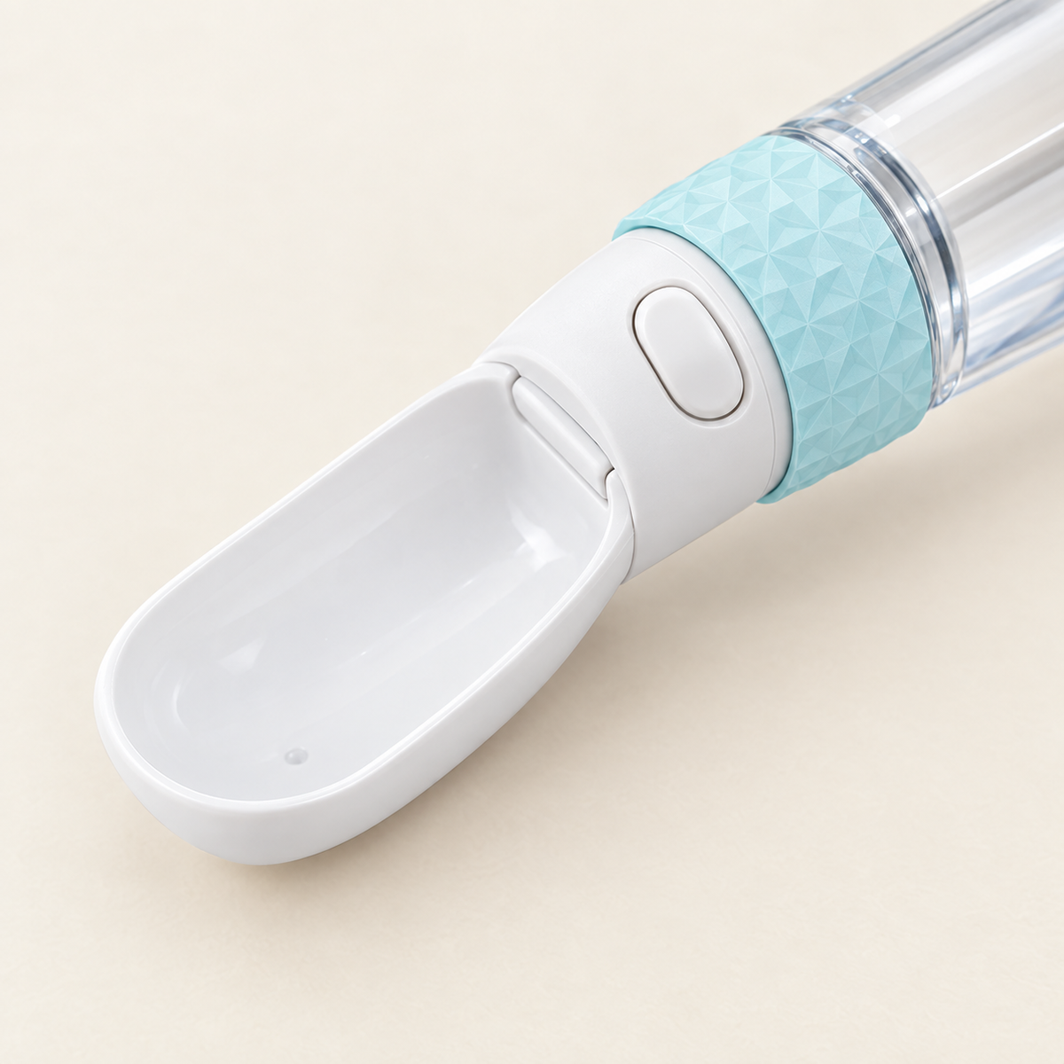 Close detail of the flip-out drinking trough and the one-touch release button on the bottle neck