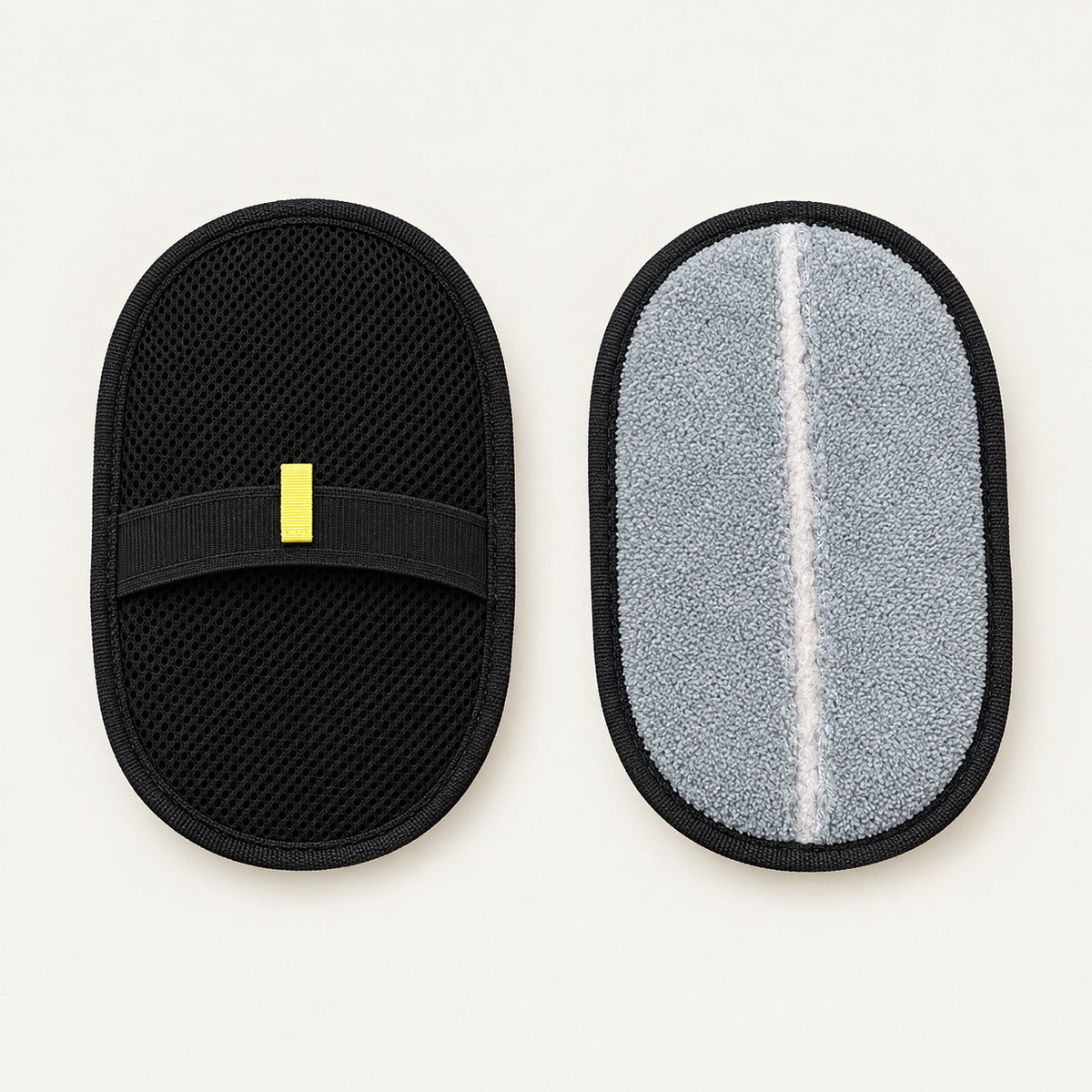 Two oval pet grooming mitts, one showing the black mesh top face with elasticated hand strap, the other turned to show the grey microfibre reverse